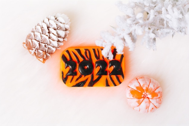 Christmas and New Year decorations pine cone mandarin 2022 on a light Flat lay Handmade soap