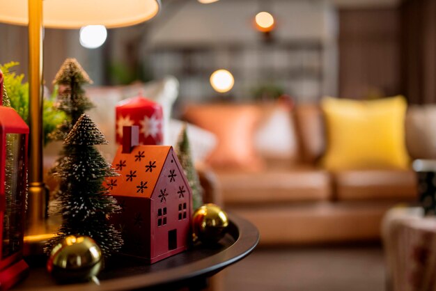 Photo christmas and new year festive backgroundred color home model decorative items on side table in living room apartment residential with light bokeh happiness joyful event