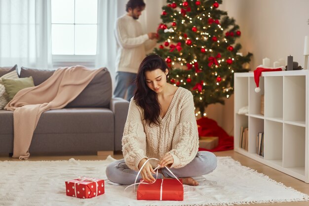 Christmas and new year gift wrapping by woman at home during winter holidays