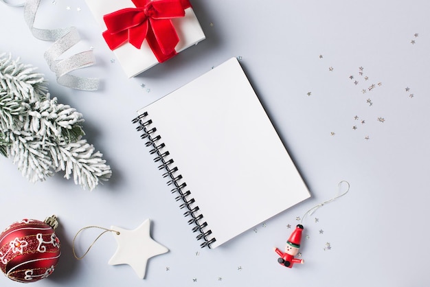 Christmas and new year goal planning mock up with note and decoration on white background and backdrop flat lay copy space top view