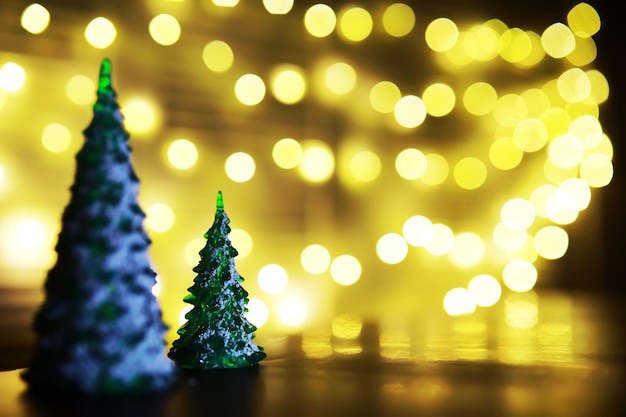 Christmas and New Year holiday background with copy space. Winter holiday background with frozen fir, glitter lights, bokeh.