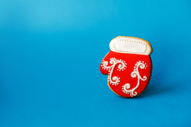 Christmas New Year holiday , red christmas sock gingerbread cookie on blue  copyspace. holiday 