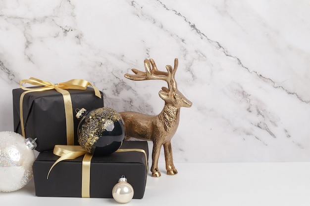 Christmas new year's eve composition. boxes of gifts and christmas decorations on a white marble background