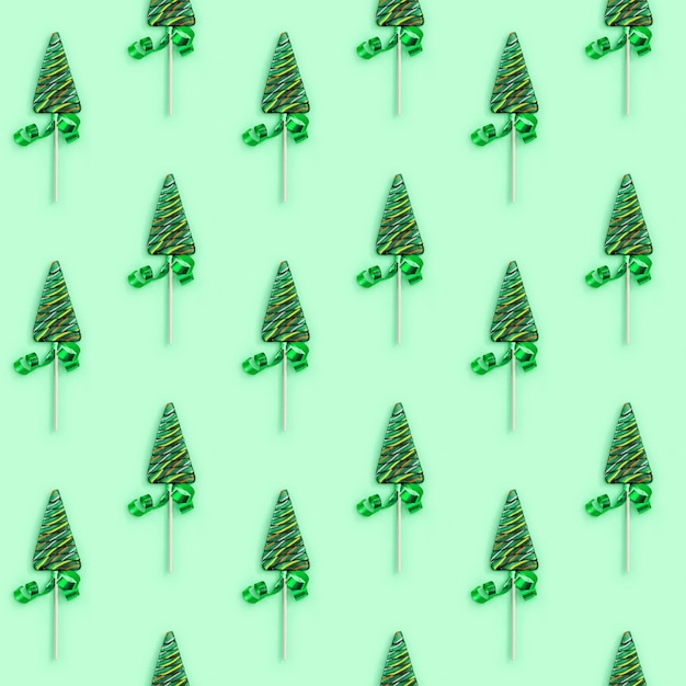 Christmas and New Year seamless pattern with lollipops shaped like Christmas tree