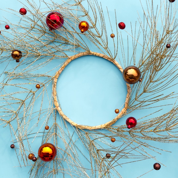 Christmas or new year winter composition. Round frame made of golden tree branches and decorative Christmas ornaments.