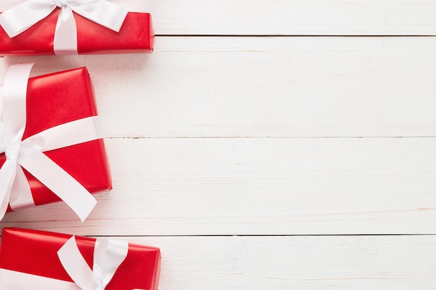 Christmas and new year with red gift boxes decoration on white wooden table background top view with copy space.