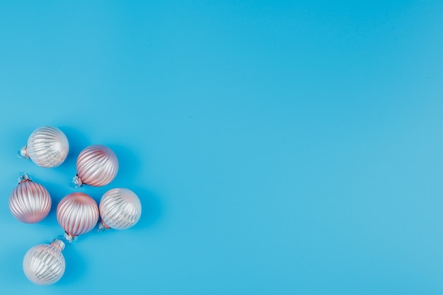 Christmas or New Years minimalistic background, with Christmas balls on blue