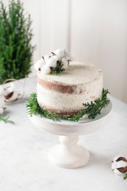 Christmas nude cake with white cream and christmas decoration, selective focus image