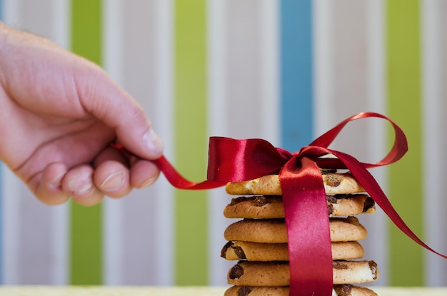 Christmas oatmeal cookies, biscuits on a light background with a beautiful bokeh from a garland.