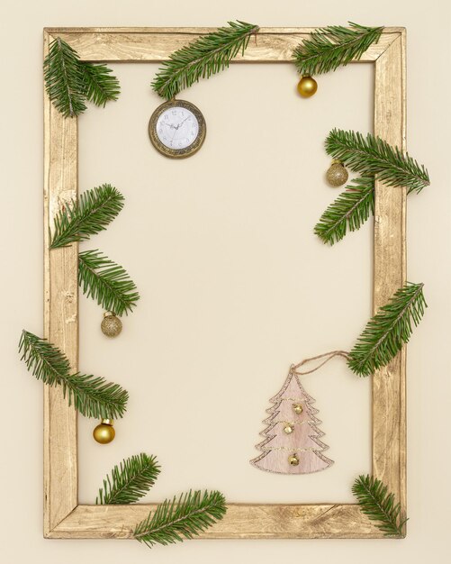Christmas old wooden frame with green fir tree branches, golden christmas balls. Happy New Year holiday background. Christmas, winter, new year concept. Flat lay, top view.
