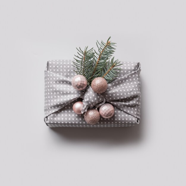 Christmas one eco gift in textile decorated natural fir tree and balls.