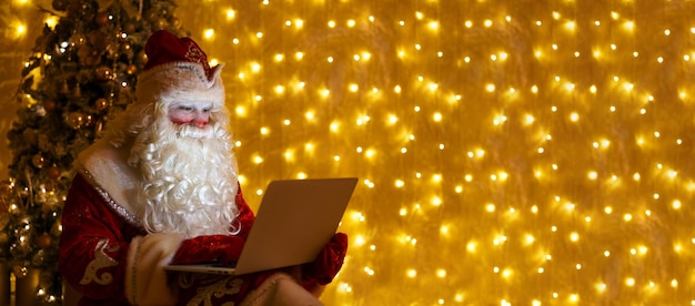 Christmas online greetings from santa claus santa claus using laptop in distance christmas call kids...