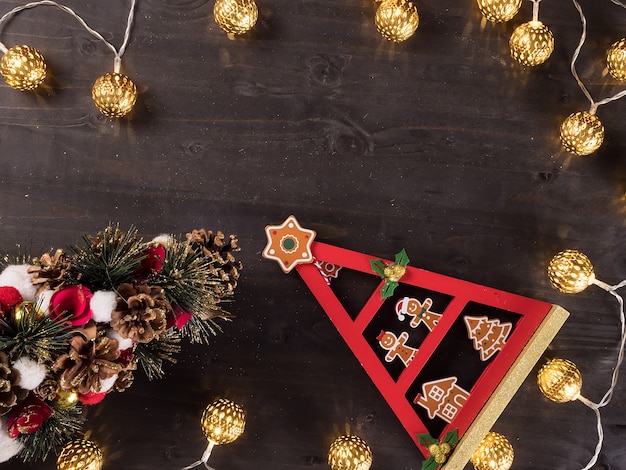 Christmas ornament and christmas lights on vintage wooden background. Holiday symbol.