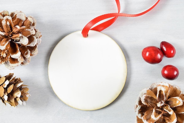 Photo christmas ornament mockup with fresh cranberries and pine cones