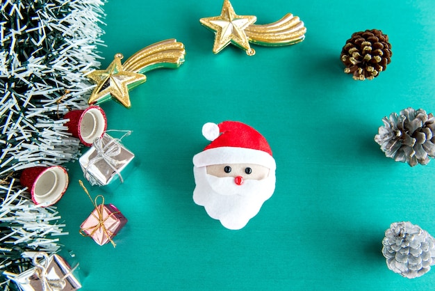 Christmas ornaments and gifts on green background.