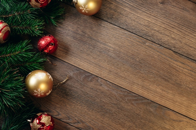 Christmas ornaments and pine branches on a wooden table. Holidays christmas . copyspace . View from above.