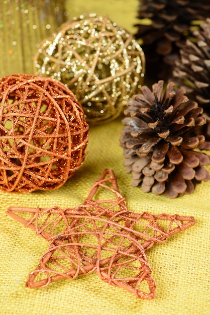 Christmas ornaments on table with yellow jute fabric