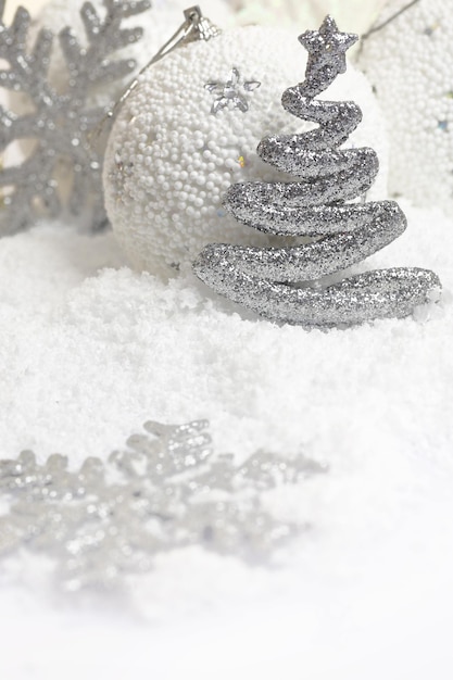 Christmas ornaments on white snowy background