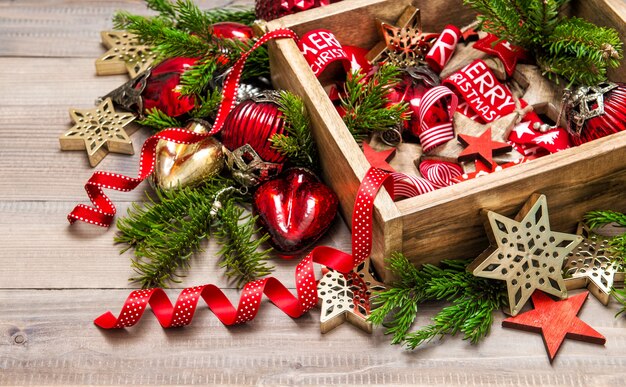 Christmas ornaments with christmas tree branches. Festive red and golden decoration