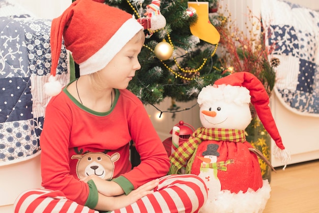 Christmas pajama little boy near Christmas tree