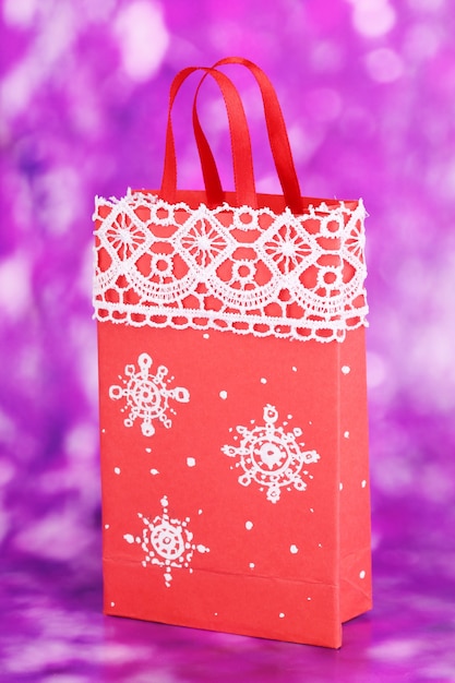 Christmas paper bag for gifts on purple background