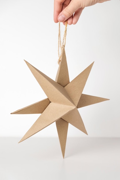 Christmas Paper Star and Ball Decoration Handmade Christmas Nordic Decor on a Light Background against the Wall Boho Scandinavian Style Design DIY Minimal Ornament Structural Origami Zero Waste