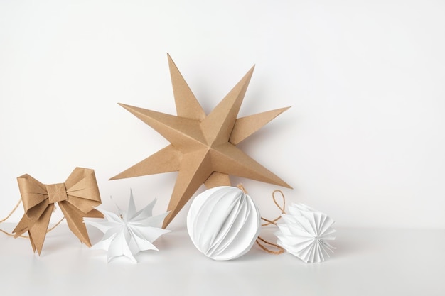 Christmas Paper Star and Ball Decoration Handmade Christmas Nordic Decor on a Light Background against the Wall Boho Scandinavian Style Design DIY Minimal Ornament Structural Origami Zero Waste