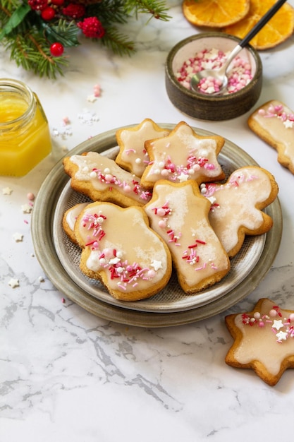 Christmas pastries Homemade gingerbread cookies with glaze on a marble countertop Copy space