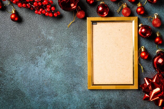 Christmas photo frame mock up template with decoration on dark background. View from above. New year mockup. New year composition with champagne bottle and decor. New year 2022