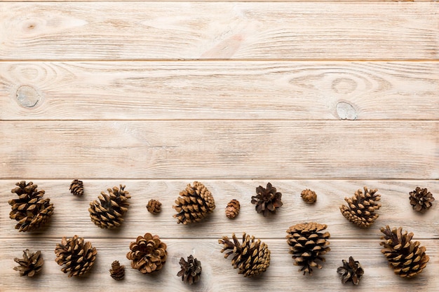 Christmas pine cones on colored paper border composition Christmas New Year winter concept Flat lay top view copy space