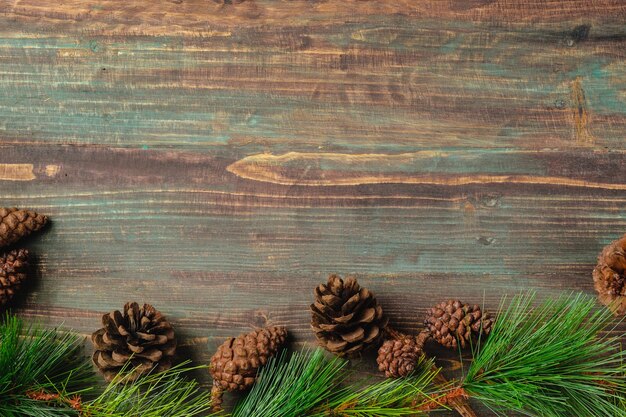 Christmas pine tree fir with pine cone decoration on vintage rustic wood table background