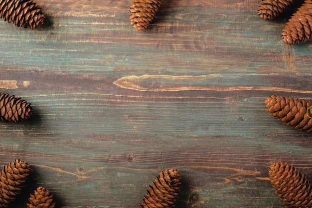 Christmas pine tree fir with pine cone decoration on vintage rustic wood table background