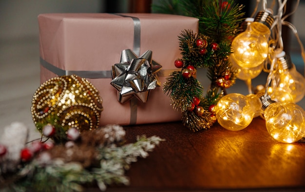 Christmas pink gift box on a background of glowing lights