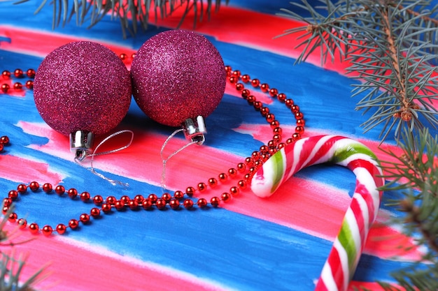 Christmas pink toys candy cane Christmas tree branches on a bluepink background Christmas concept Closeup