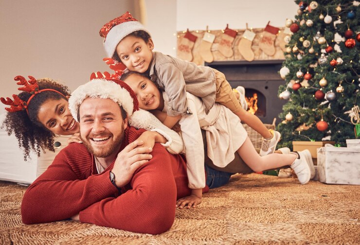 Photo christmas portrait and happy family in home on floor bonding and together xmas smile and face of parents with children interracial and african mom with father for party celebration or holiday