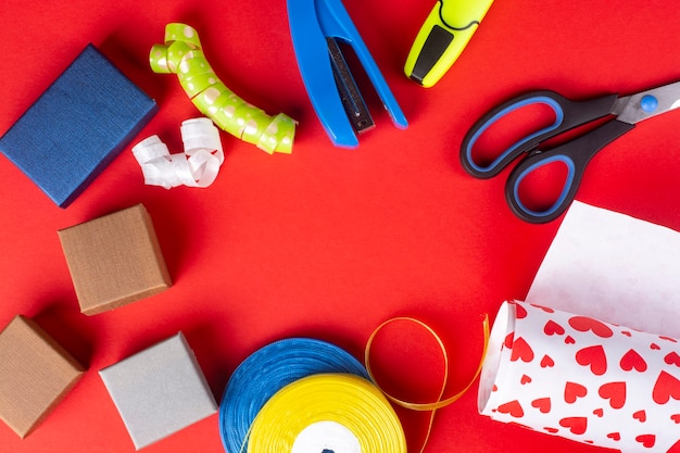 Christmas preparation gift boxes wrapping on red background