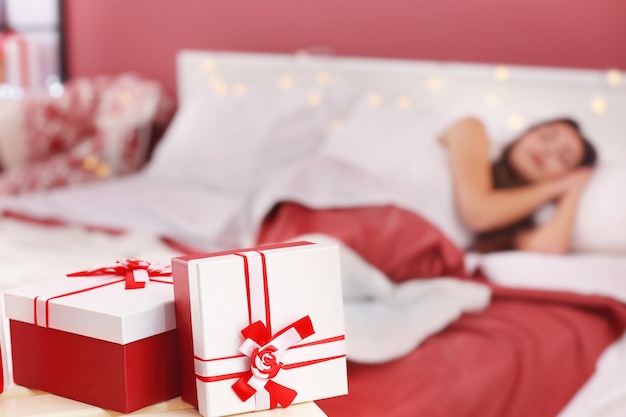 Christmas presents and blurred sleeping woman