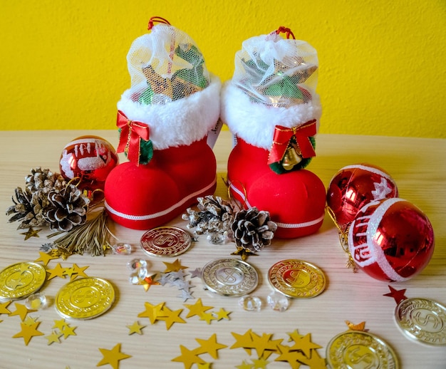 Christmas presents with red toys and cones on wooden background in vintage style