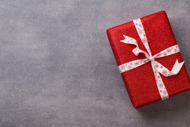 Christmas presents with ribbon on grey  background.