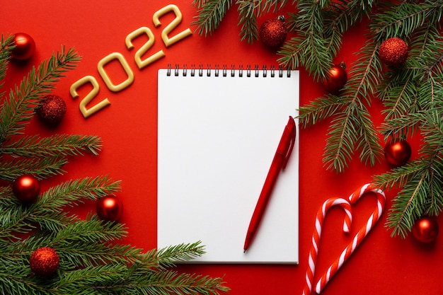 Christmas red background with spruce branch in the upper right corner copy space
