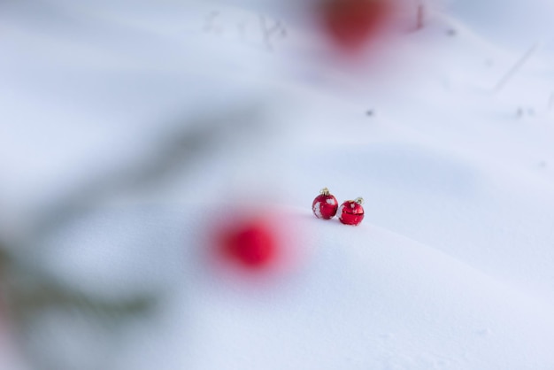 christmas red balls with long shadows  in fresh snow on beautiful sunny winter day