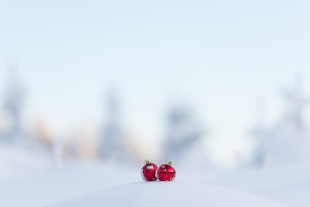 christmas red balls with long shadows  in fresh snow on beautiful sunny winter day