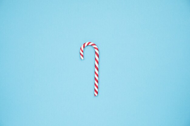 Christmas red candy cane on blue background