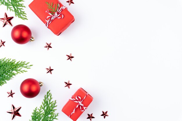 Christmas red gift box with spruce branches, red berries on white background.