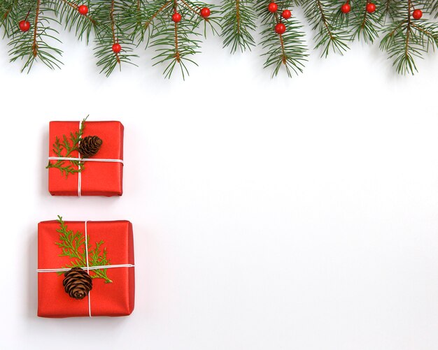 Christmas red gift boxes decorated with cone on white 