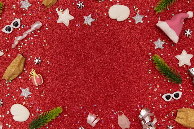 Christmas red glitter background with santa hat medical mask and festive elements