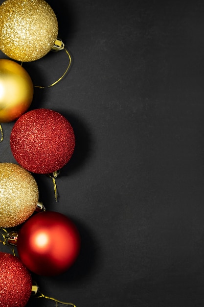 Christmas red and gold decorations on a dark background flat lay top view