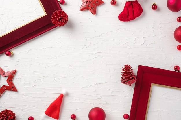 Christmas red picture frame and bauble decoration ornament on white concrete table background