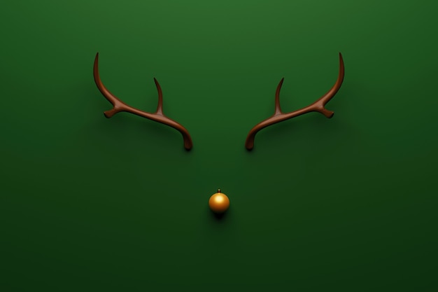 Christmas reindeer concept made of wooden and gold bauble decoration and antlers on green background