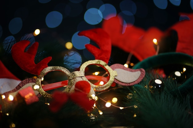 Christmas Reindeer Glasses On Fir Branch. Beautiful Lights Bokeh